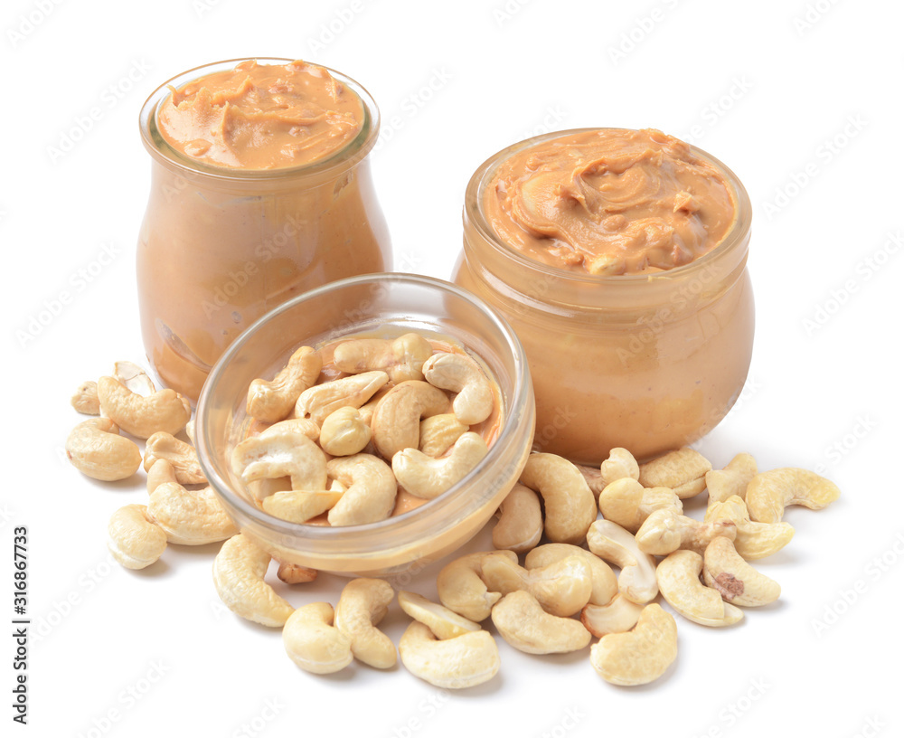 Jars of cashew butter on white background