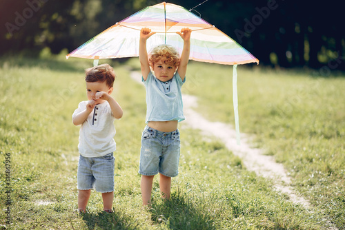 Little child in a summer field. Kids playing with a Kite photo