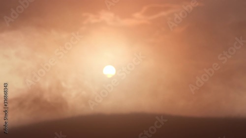Dramatic landscape of foggy sunset. Amazing cosmic weather. Fog moving on ground of deserted planet. Mysterious natural phenomenon. Bright sun and cloudy sky on abstract background. Fantasy concept