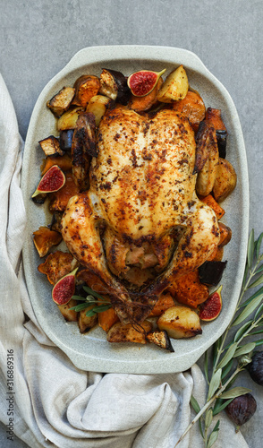 Roasted chicken with rosemary and  Sweet potato. served on grey stone, latin american food, top view