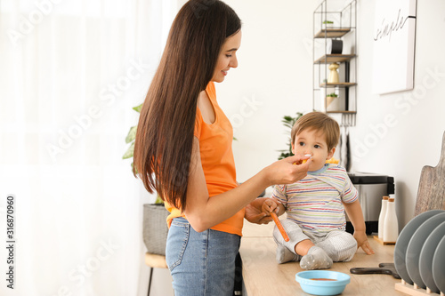 Mother feeding her little s...