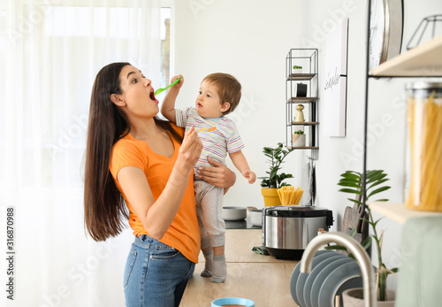 Mother feeding her little s...