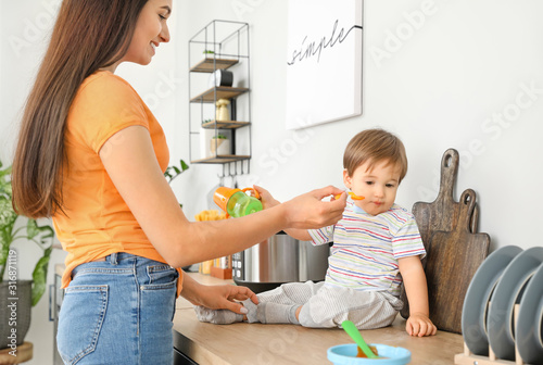 Mother feeding her little s...