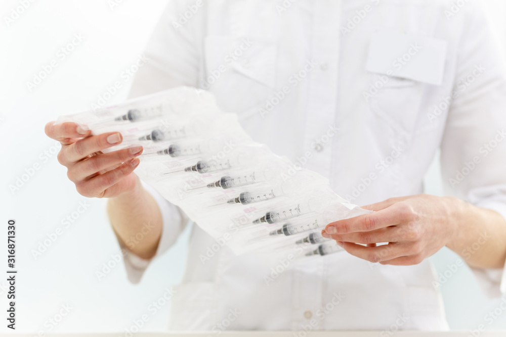 pharmacist holds a pack of injections pharmacist holds a pack of injections