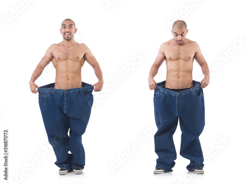 Man in dieting concept with oversized jeans