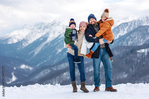 happy family mother father and children on winter nature .