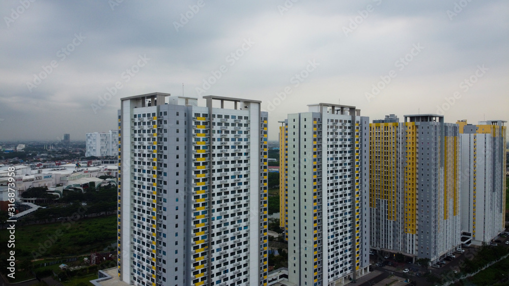 Obraz premium Bekasi, West Java, Indonesia - January 21 2020: Aerial landscape of modern apartment building in Bekasi central business district from a drone.