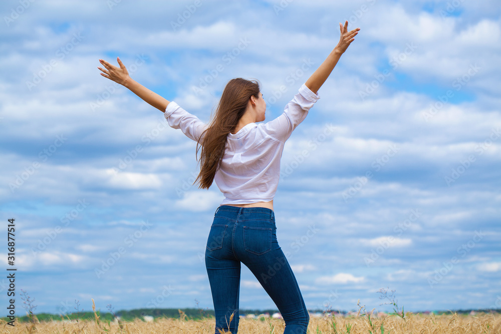 Young brunette woman in white shirt and blue jeans Young brunette woman in white shirt and blue jeans