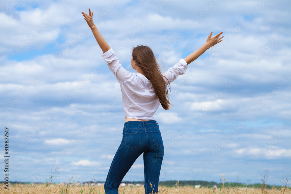 Young brunette woman in white shirt and blue jeans Young brunette woman in white shirt and blue jeans