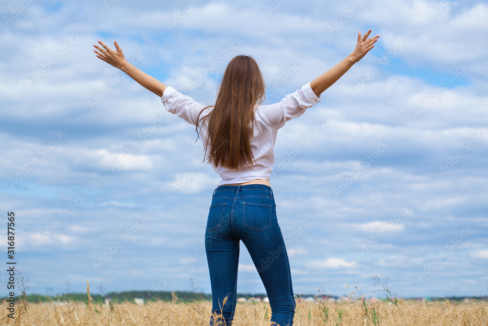 Young brunette woman in white shirt and blue jeans Young brunette woman in white shirt and blue jeans