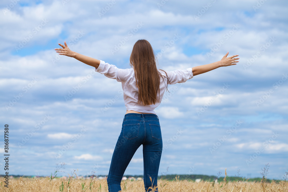 Young brunette woman in white shirt and blue jeans Young brunette woman in white shirt and blue jeans