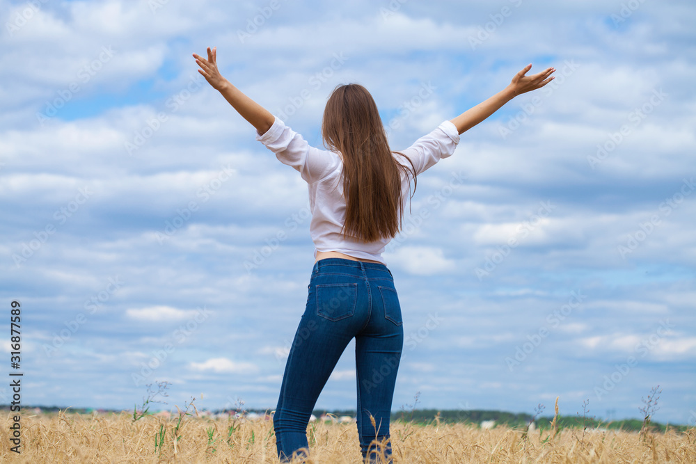 Young brunette woman in white shirt and blue jeans Young brunette woman in white shirt and blue jeans