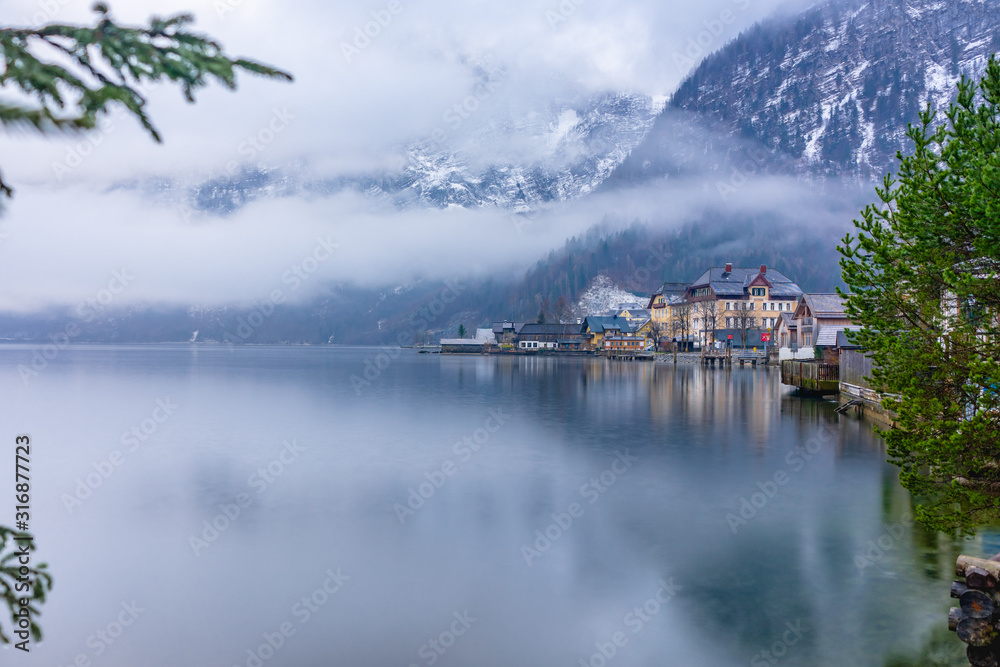 Hallstatt diveded between its lake, the sky and the clouds
