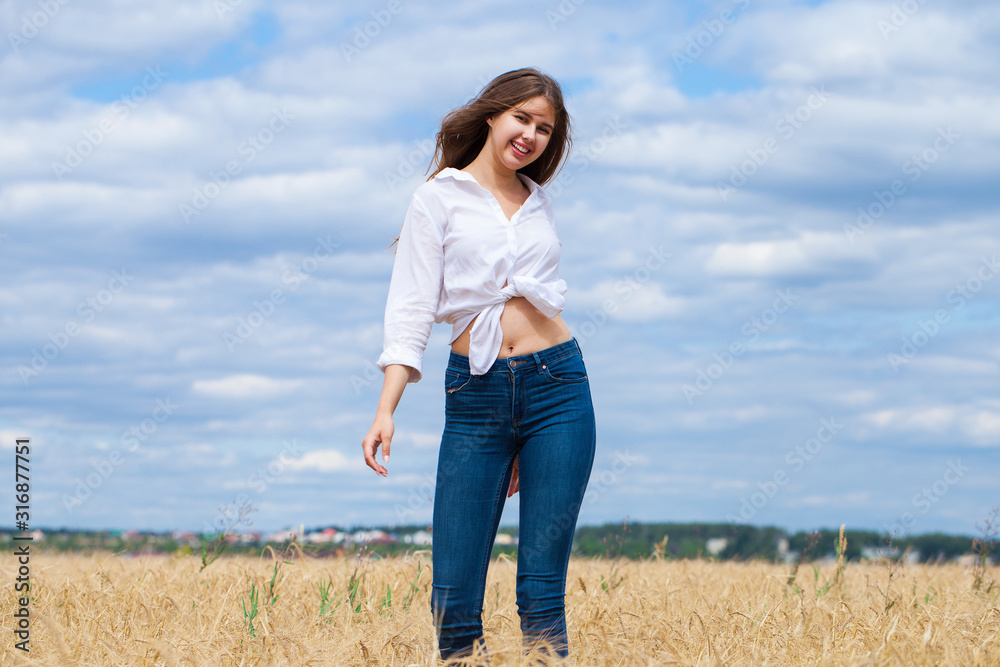 Young brunette woman in white shirt and blue jeans shorts Young brunette woman in white shirt and blue jeans shorts
