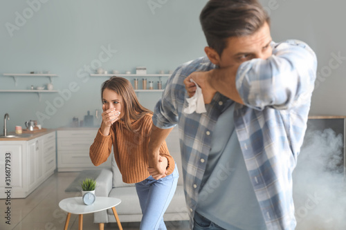 Young couple gasping at hom...