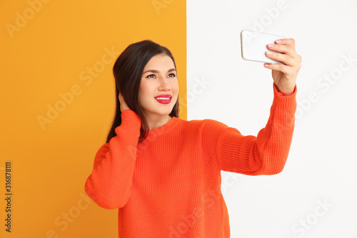 Beautiful young woman takin...