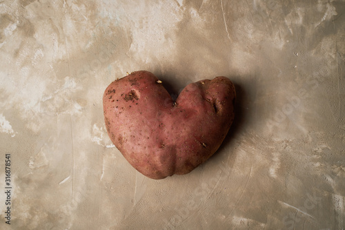 Ugly food, potatoes in the shape of a heart. Natural and simple farm products.