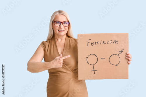 Lady holding cardboard with...
