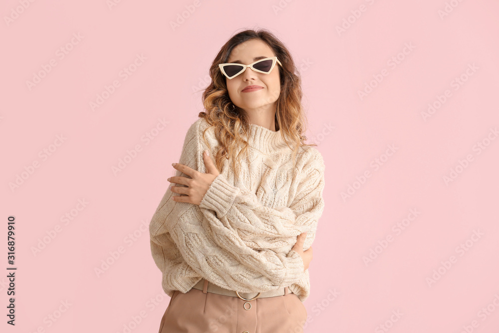 Beautiful young woman in warm sweater on color background Beautiful young woman in warm sweater on color background