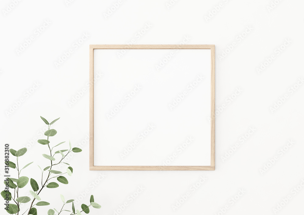 Fototapeta Makieta plakat wnętrz z kwadratową drewnianą ramą na pustej białej ścianie ozdobiony gałąź rośliny z zielonymi liśćmi. Renderowanie 3D, ilustracja.