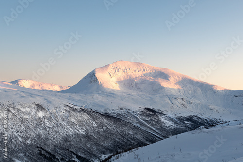 Snow capped mountain in winter photo