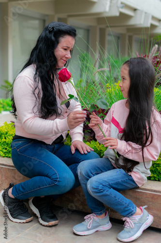Colombian Latin American girl gives her mother a rose on Mother's Day © Oscar
