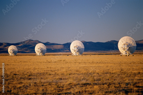 VLA Very Large Array radio telescope dishes scattered in field photo