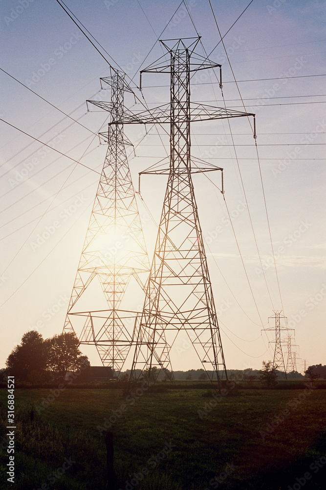 Fototapeta premium Silhouetted pylons and cables