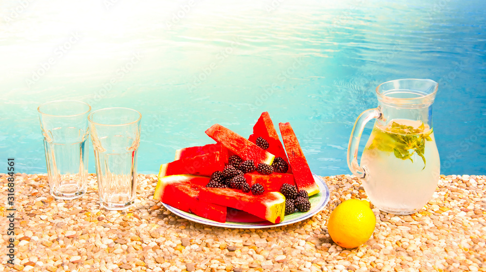 Refreshing melon plate with blackberries and cold lemonade