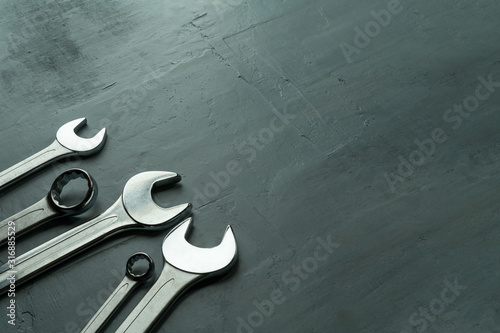 Open-end wrenches on textured background.