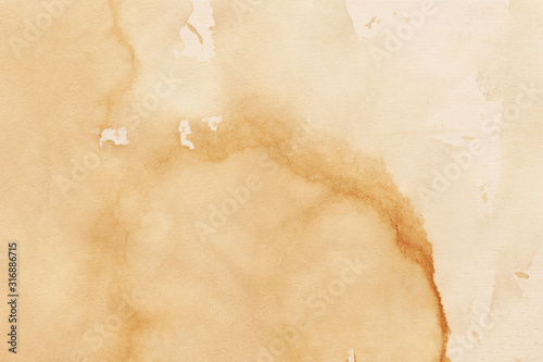 Vintage and old looking coffee cup stain background. Painted with a tea retro texture. Grunge paper for drawing. Ancient book page.