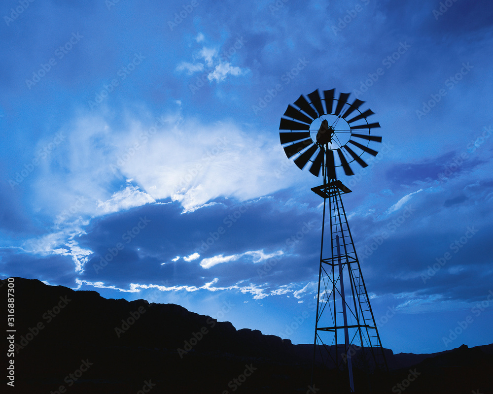 Windmill at dusk with cloudy sky Windmill at dusk with cloudy sky