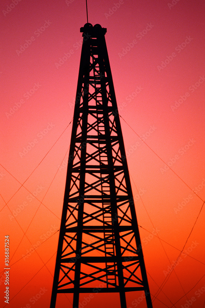 Oil drilling rig at sunset