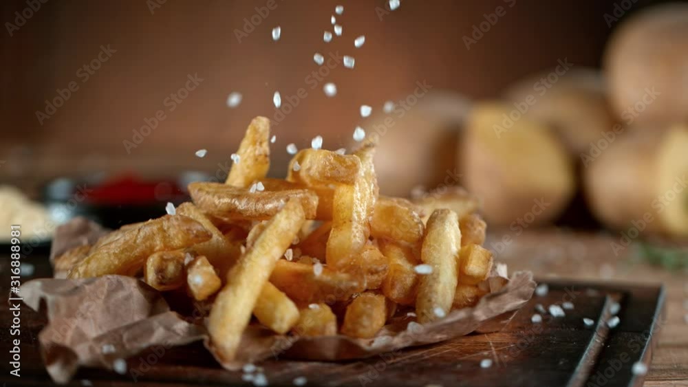 Super Slow Motion Shot of adding Salt on Fresh French Fries at 1000fps.