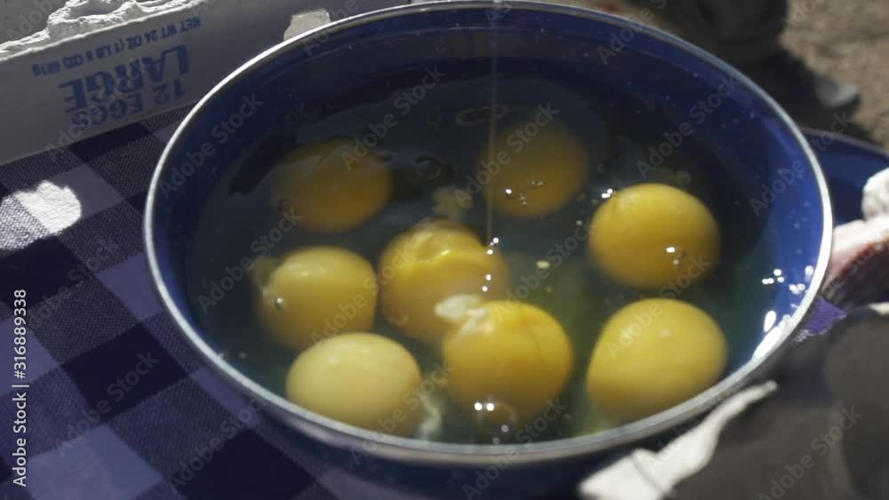 Scrambled Eggs yokes dropping Camping at Campsite Closeup Scrambled Eggs yokes dropping Camping at Campsite Closeup