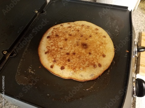 pancake cooking on a griddle or stove
