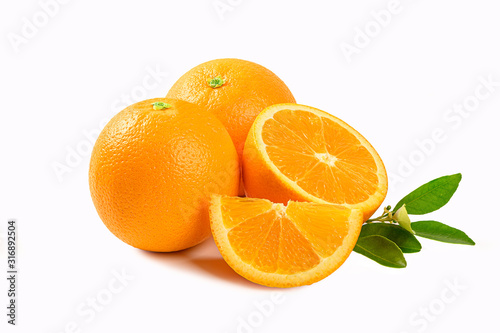 Fresh oranges with half and leaves isolated on white background