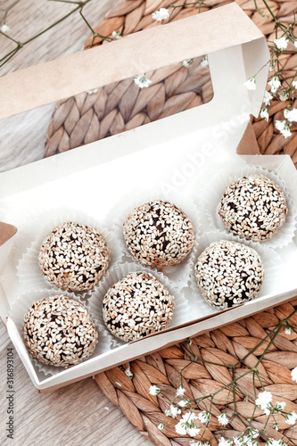 Sweets with sesame seeds. Raw handmade sweets. Healthy low-calorie sweets for vegetarians.