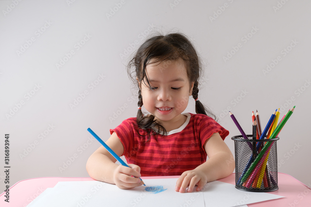 Little curly asian girl enjoy drawing at home. Education Concept. Little curly asian girl enjoy drawing at home. Education Concept.