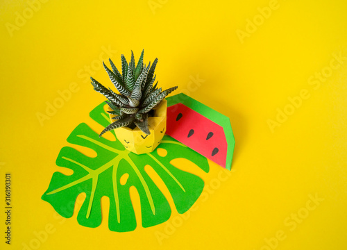 Fototapeta Naklejka Na Ścianę i Meble -  Tropical fruits made of paper. Pineapple flower in a pot.