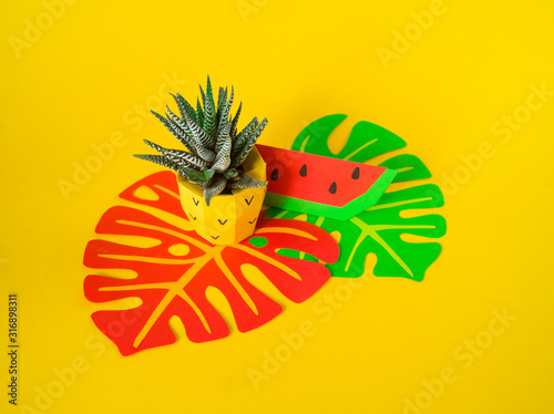 Fototapeta Naklejka Na Ścianę i Meble -  Tropical fruits made of paper. Pineapple flower in a pot.