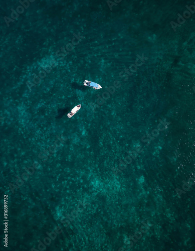 Aerial photography of a boat in the caribbean sea