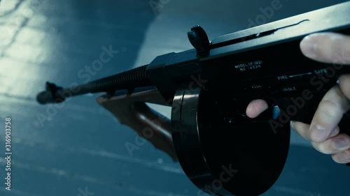 pointing a tommy machine gun