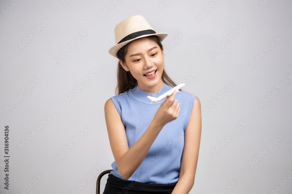 Fototapeta premium Tourist woman in summer casual clothes.Asian Smiling woman .Passenger traveling abroad to travel on white background.Asian woman going to summer vacation.Travel trip funny.