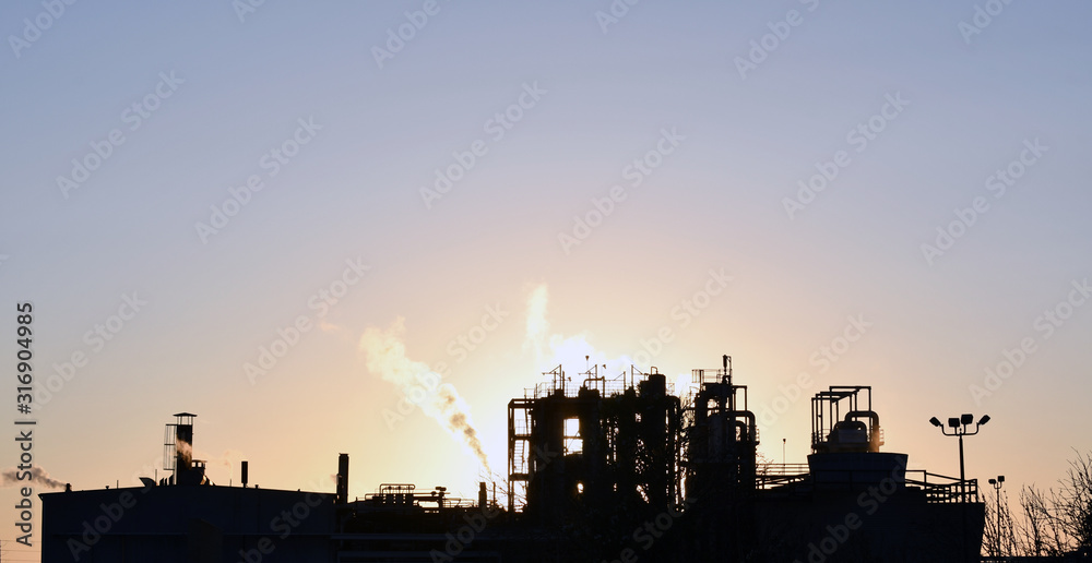 Fototapeta premium A large factory at sunset