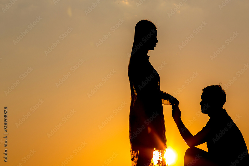 Silhouette of lovers holding hands - hugging together at sunset, love in love Concept: decoration, design, valentine.