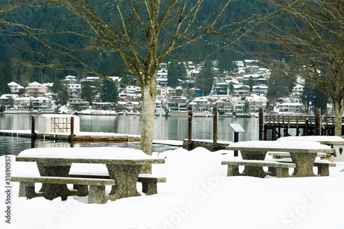 Resting place benches and tables covered with snow flakes. Winter park . © unicorn2013
