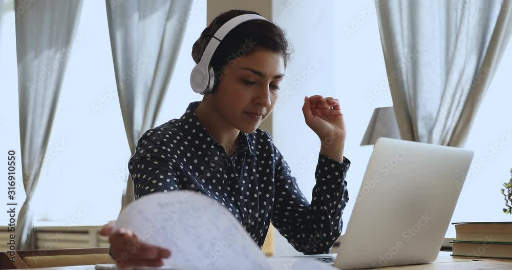 Indian girl internet teacher wear headphones teach online by webcam