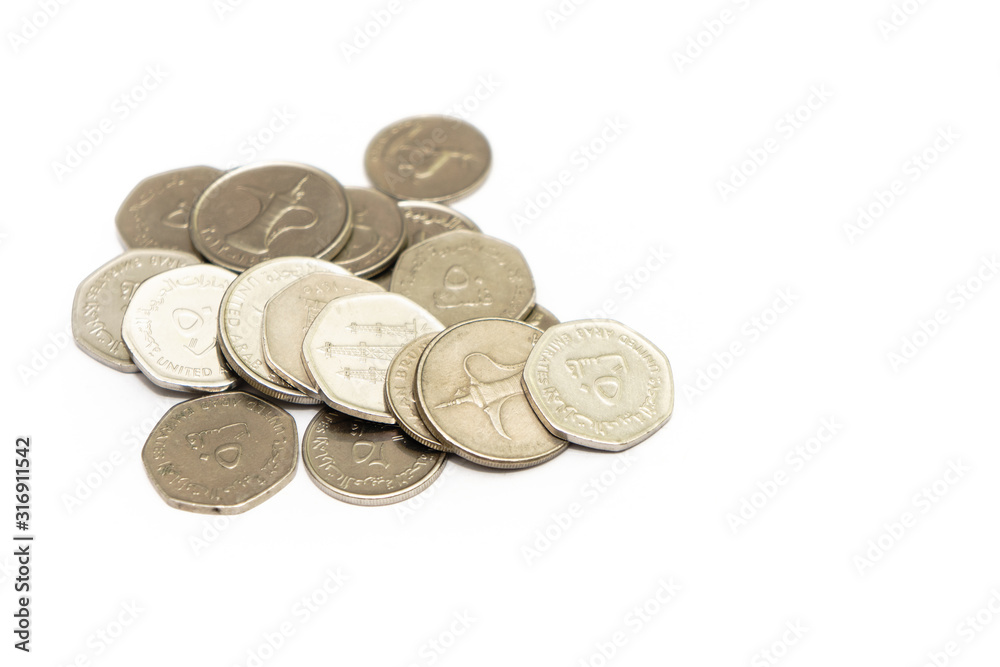 United Arab Emirates cash notes and coins isolated on white background. selective focus. high key United Arab Emirates cash notes and coins isolated on white background. selective focus. high key