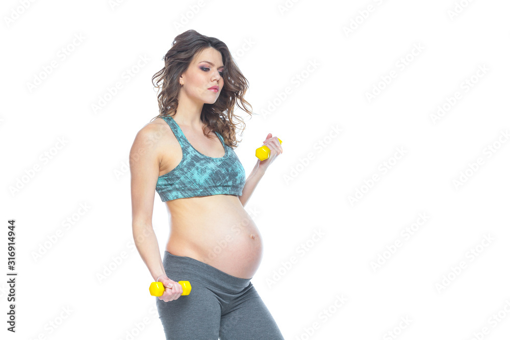 Pregnant woman training with dumbbells to stay active. Pregnant woman practicing fitness and working out during pregnancy Slim pregnant woman is engaged in fitness. Isolated white background. Pregnant woman training with dumbbells to stay active. Pregnant woman practicing fitness and working out during pregnancy Slim pregnant woman is engaged in fitness. Isolated white background.